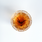 Close-up of brewed Himalayan Golden Black tea, golden amber liquor in a glass tea cup