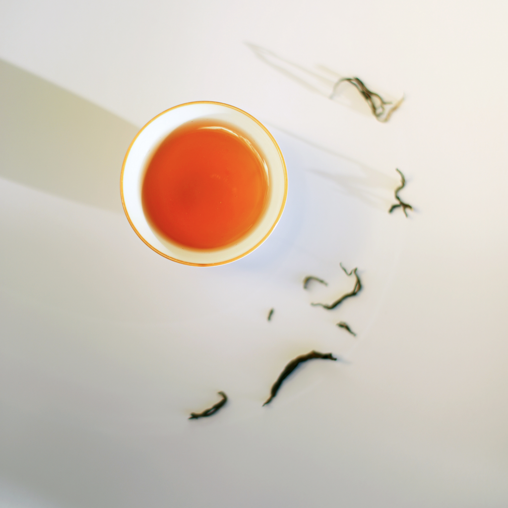 Himalayan Golden Black second flush tea, brewed cup with long twisted whole leaves
