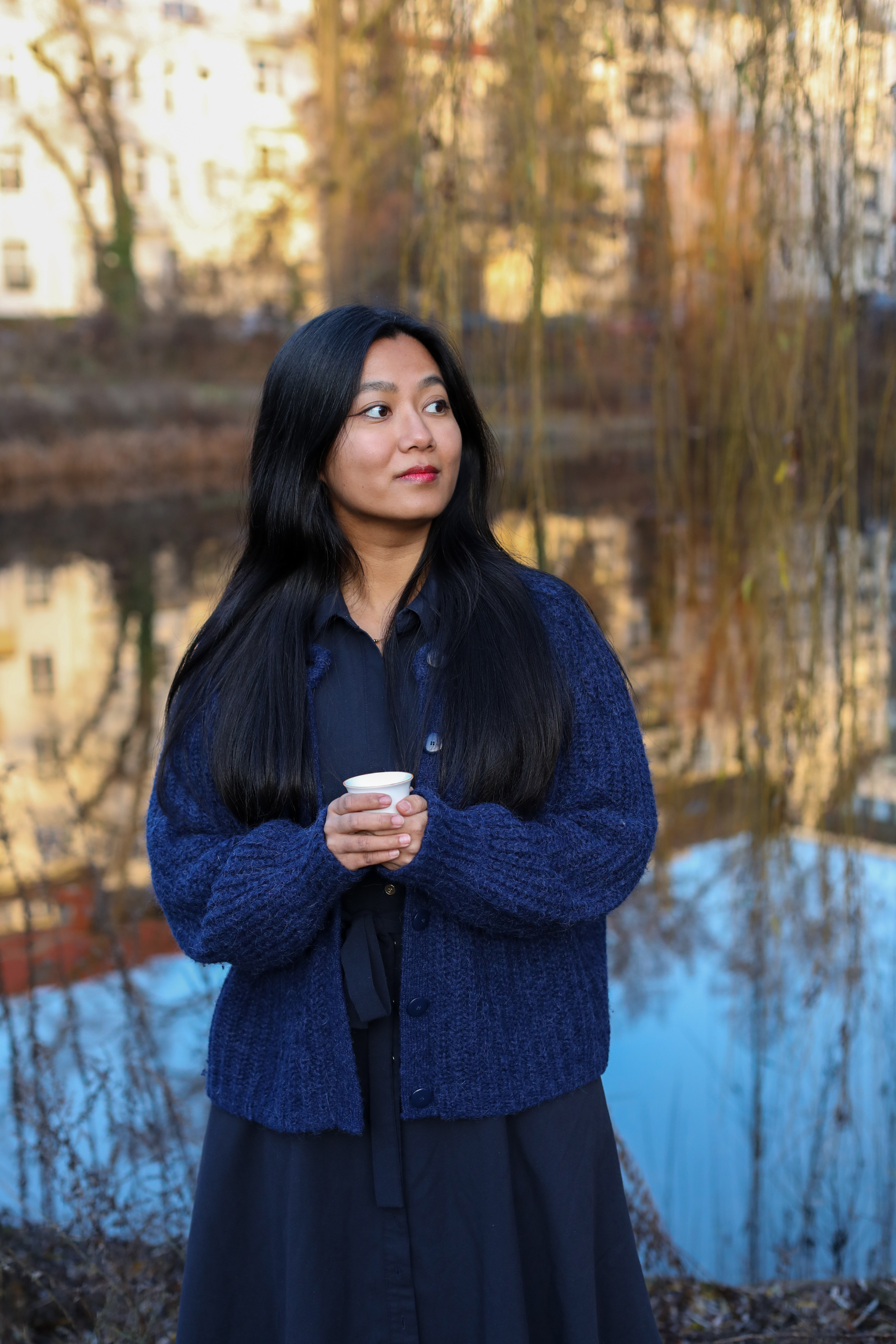 Swikriti, founder of Himali Cup, holding a tea cup in Berlin