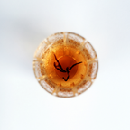 Close-up of brewed Rare Red Oolong tea, amber liquor in a glass tea cup