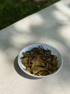 Spring Delight First Flush brewed whole leaf Himalayan tea on a white plate in natural sunlight