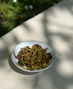 Spring Moonlight First Flush whole leaf Himalayan tea on a white plate in natural sunlight